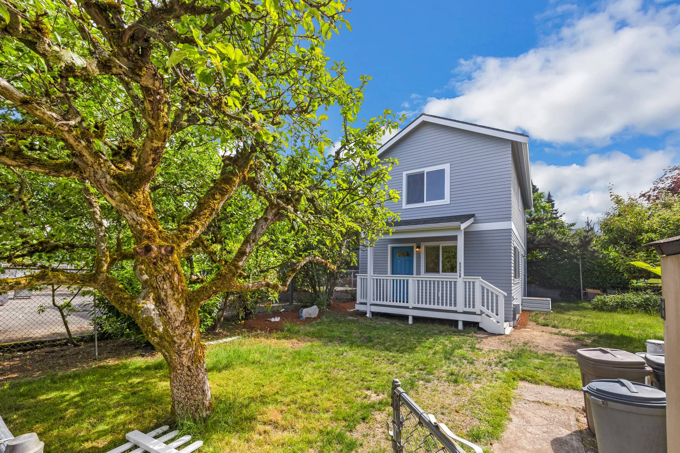 Detached ADU built by DIGS Construction sharing a Seattle-area backyard with a mature tree
