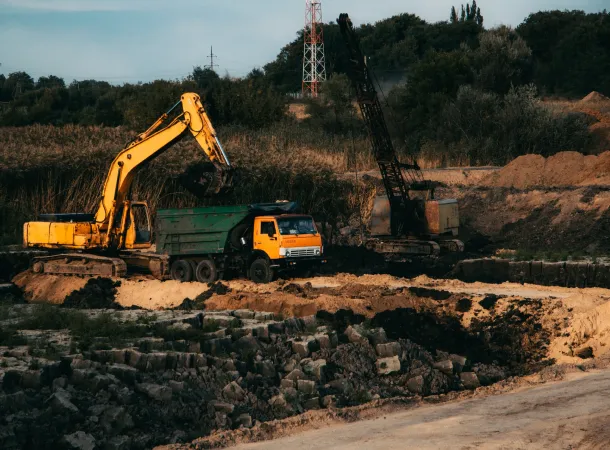 land clearing excavator and dump truck with crane